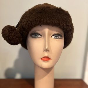 British brown shearling cap with pom poms.